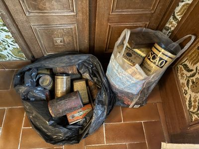 a bag full of items sitting on the floor next to a door