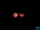 a pair of red sapphires on a black background