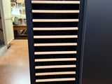 a wine cooler that has many bottles of wine in it