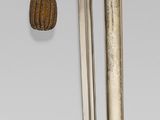 a pair of scissors hanging from a hook on a pole