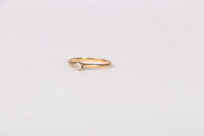 a gold ring with a single diamond on top of it