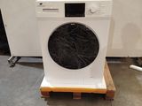 a white washing machine sitting on a pallet in a room