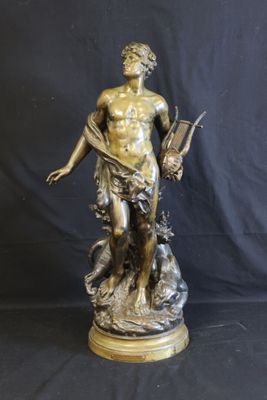 bronze statue of a man holding a book and a dog