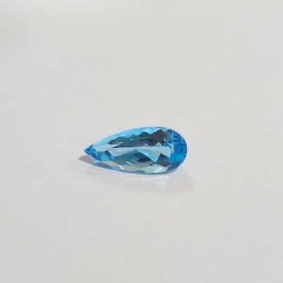 a close up of a blue topaz stone on a white surface