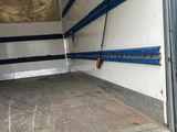 the back of a moving truck with the door open showing the inside of it