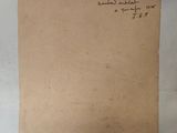an old piece of paper with writing on it sitting on top of a table