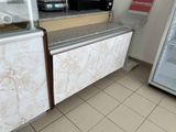 tiled floor in a restaurant with a refrigerator and a counter