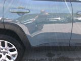 a reflection of a man in a car ' s side mirror