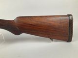 a rifle with a wooden stock and a wooden barrel