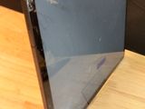 a broken laptop computer sitting on a wooden table