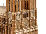 a wooden model of a cathedral with a clock on the front of it