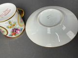 a cup and saucer sitting next to each other on a table