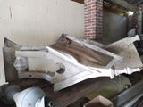 a pile of junk in a room with a brick wall