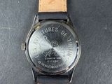 a watch that is sitting on top of a black table