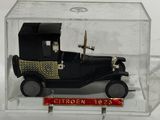 a small toy car in a clear box on a white surface