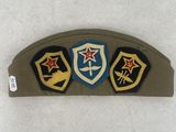 an image of a military hat with three patches on it