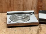 a record player sitting next to a record player on a table