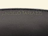 a close up of a black leather bag with a gold buckle