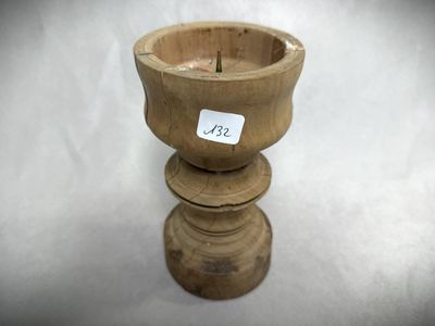 a small wooden cup with a sticker on it