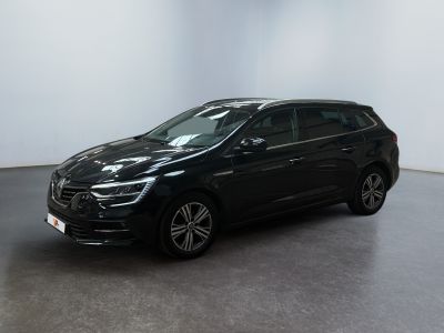 a black car parked in a room with a white wall