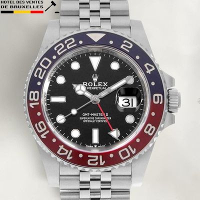 a rolex watch with a red and blue bezel on it
