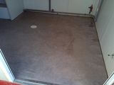 a room with a door and a floor with a hole in it