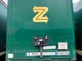 a green box truck parked in a parking lot
