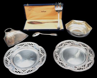 a silver plate with a spoon and a silver plate with a spoon and a silver plate with a spoon and a silver plate with a spoon and a spoon