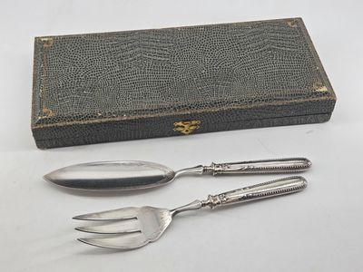 two forks and a spoon sitting next to a book