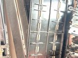 several pieces of metal are stacked on top of each other in a room