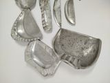a lot of silver spoons and spoons on the table