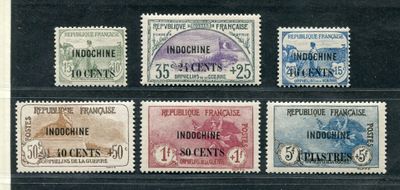 four different postage stamps with different colors on them on a black background