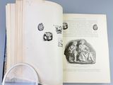 an open book with a magnifying glass next to it