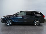 the black honda odyssey is parked in a room with a gray wall
