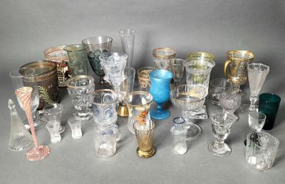 many different types of glasses and vases on the table