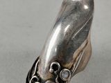 a close up of a silver ring with a stone in the middle