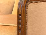 a close up of a chair with a wooden frame