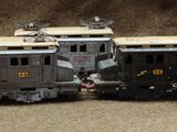 several toy trains are lined up in a row on the ground