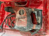 a drill in the back of a red truck