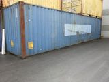a large blue container sitting in the middle of a parking lot