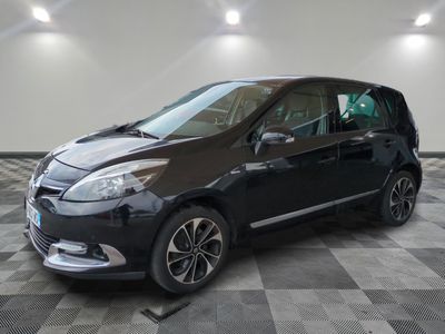 the black car is parked in the garage on a checkered floor