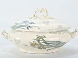a white bowl with a lid that has flowers on it