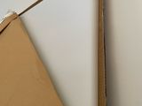 a cardboard triangle hanging on the wall next to a mirror