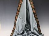 a picture of a blue and brown scarf hanging on a wall