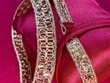 bracelets on a pink cloth with a red background