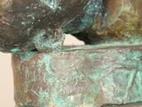 a close up of a statue of a bird on a pedestal