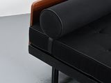 an image of a black couch with a wooden arm rest