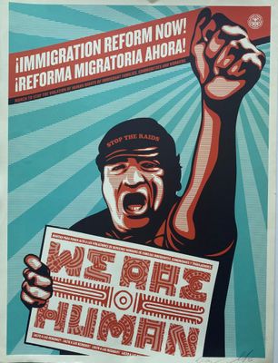 a poster of a man holding a sign in his hand