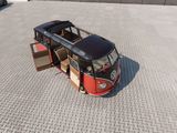 the vw bus is parked in the parking lot with its doors open