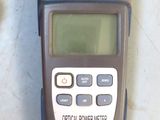 a close up of a digital power meter on a table